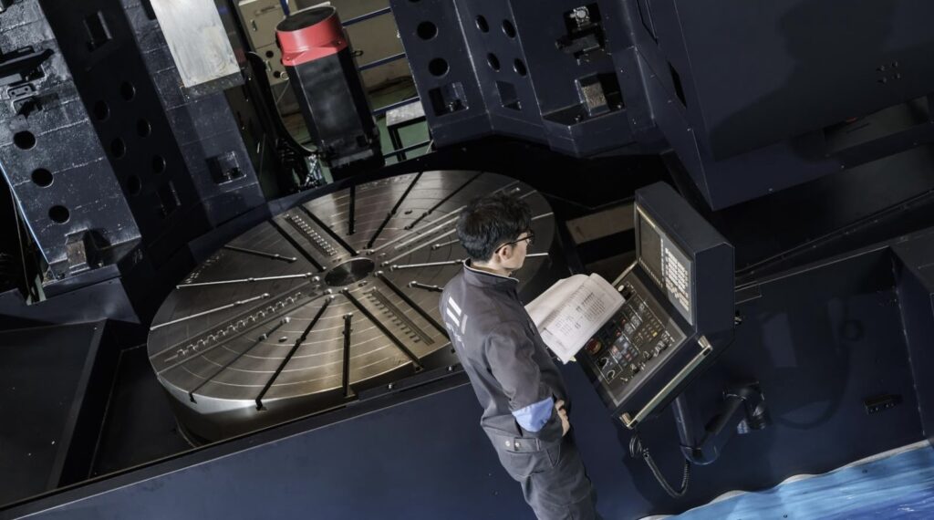 A man stands near a carousel machine