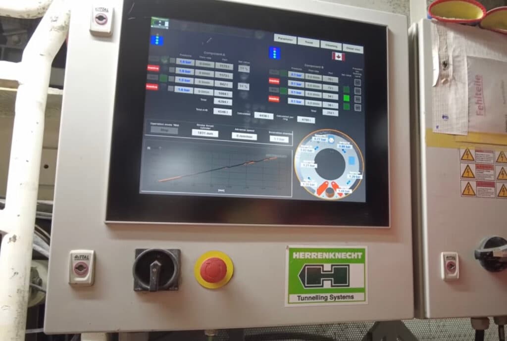A digital control panel of a tunneling system with various operational metrics displayed on the screen