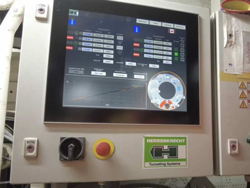 A digital control panel of a tunneling system with various operational metrics displayed on the screen